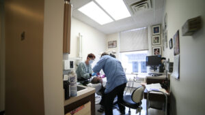 Dental professionals working on a patient.