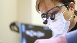 Dental professional performing an exam.