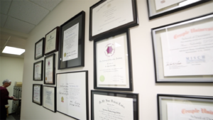 Staff accreditations hanging on a wall.