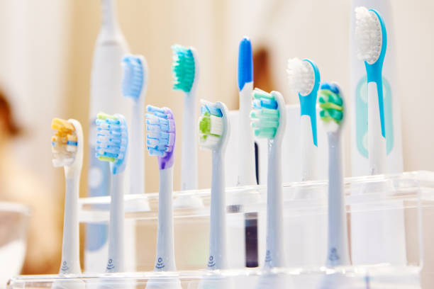 Different brush head attachments for electric toothbrushes all lined up on a small plastic display