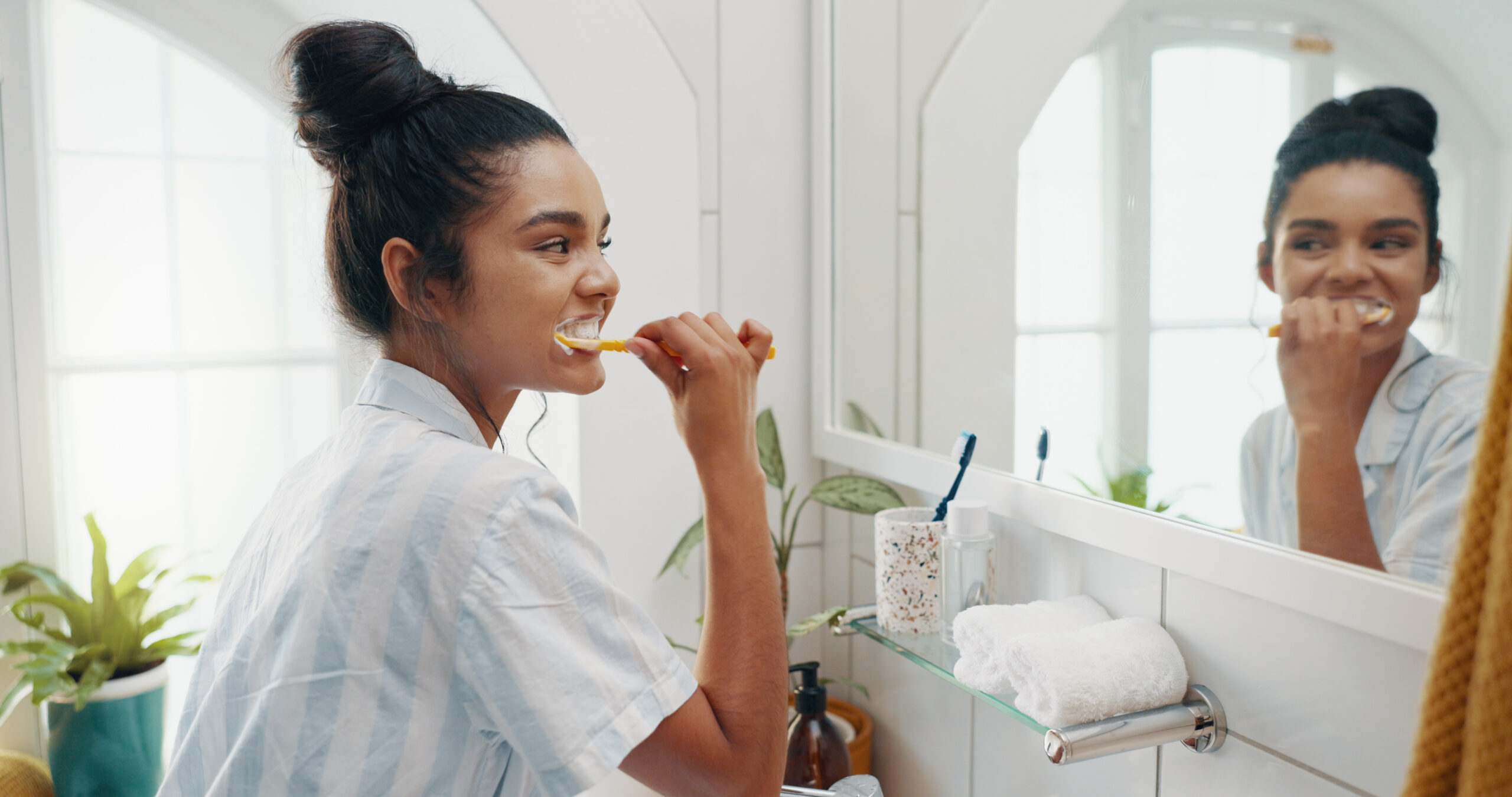 Woman brushing teeth to prevent root canal 